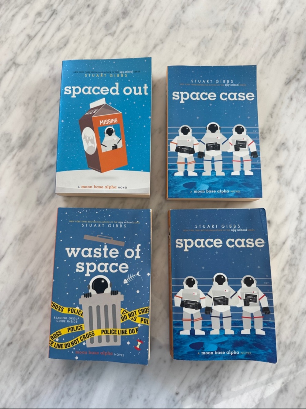 Stuart Gibbs Space series of 4. Spaced out. Space case x 2, Waste of space.